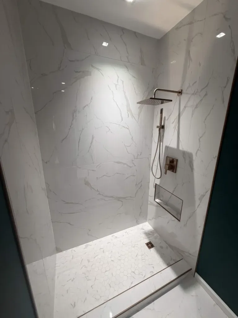 Marble-look walk-in shower with linear drain